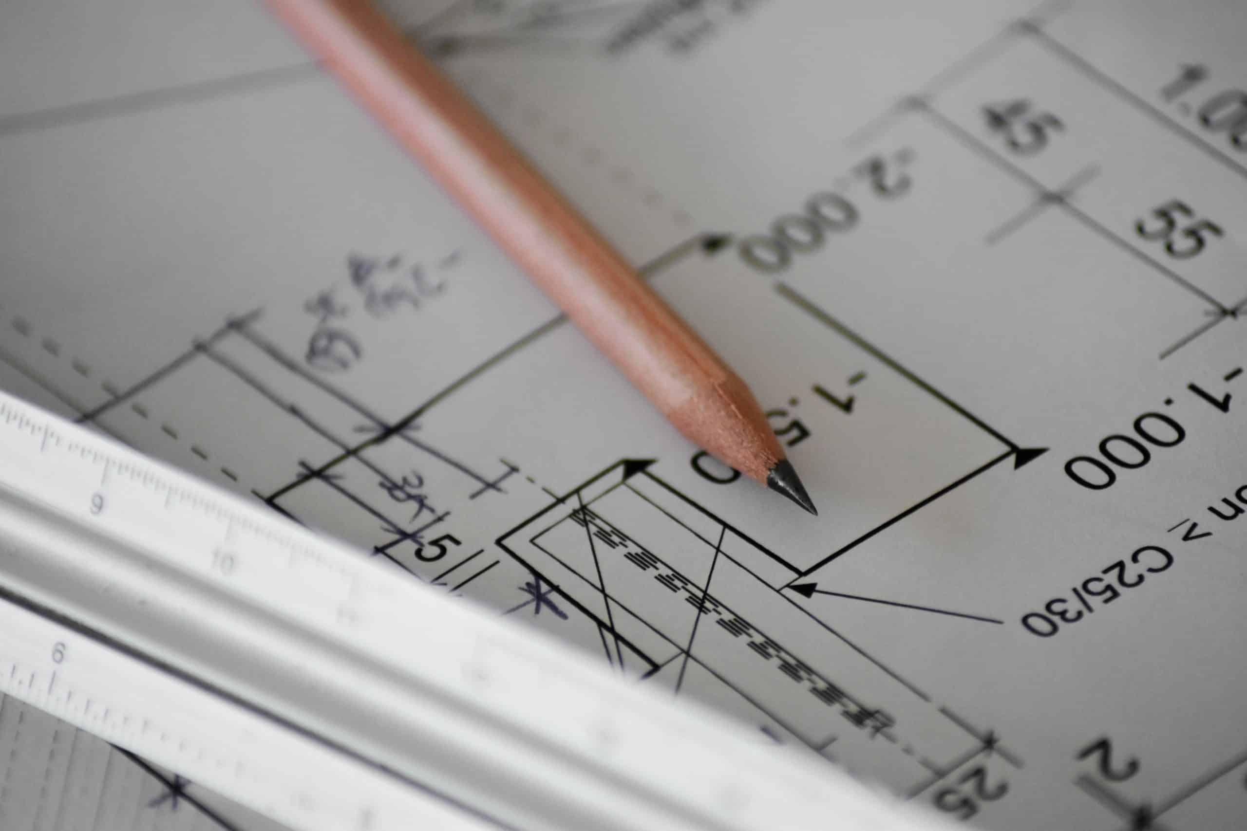 Construction plans with a pencil lying on top for mezzanine floor structural plans - ATC Installations